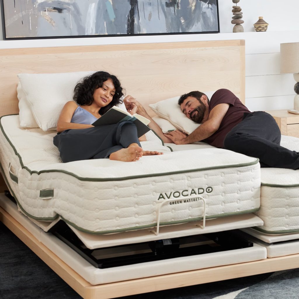 Couple reading on the Avocado Green Mattress on an adjustable base