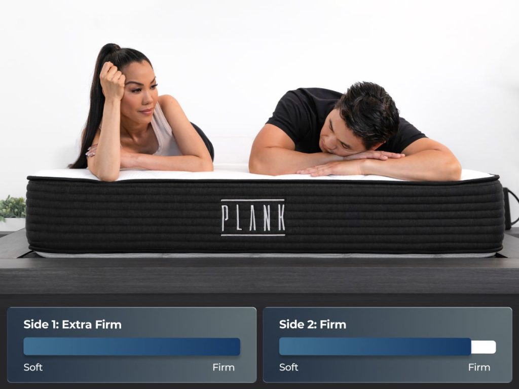 Two people resting on the Plank Firm with extra firm and firm side labels