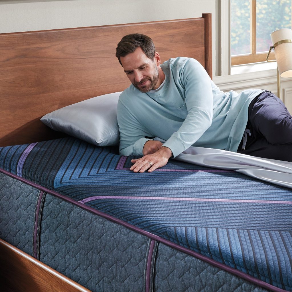 Man lying on the Beautyrest World Class Hybrid Level Three