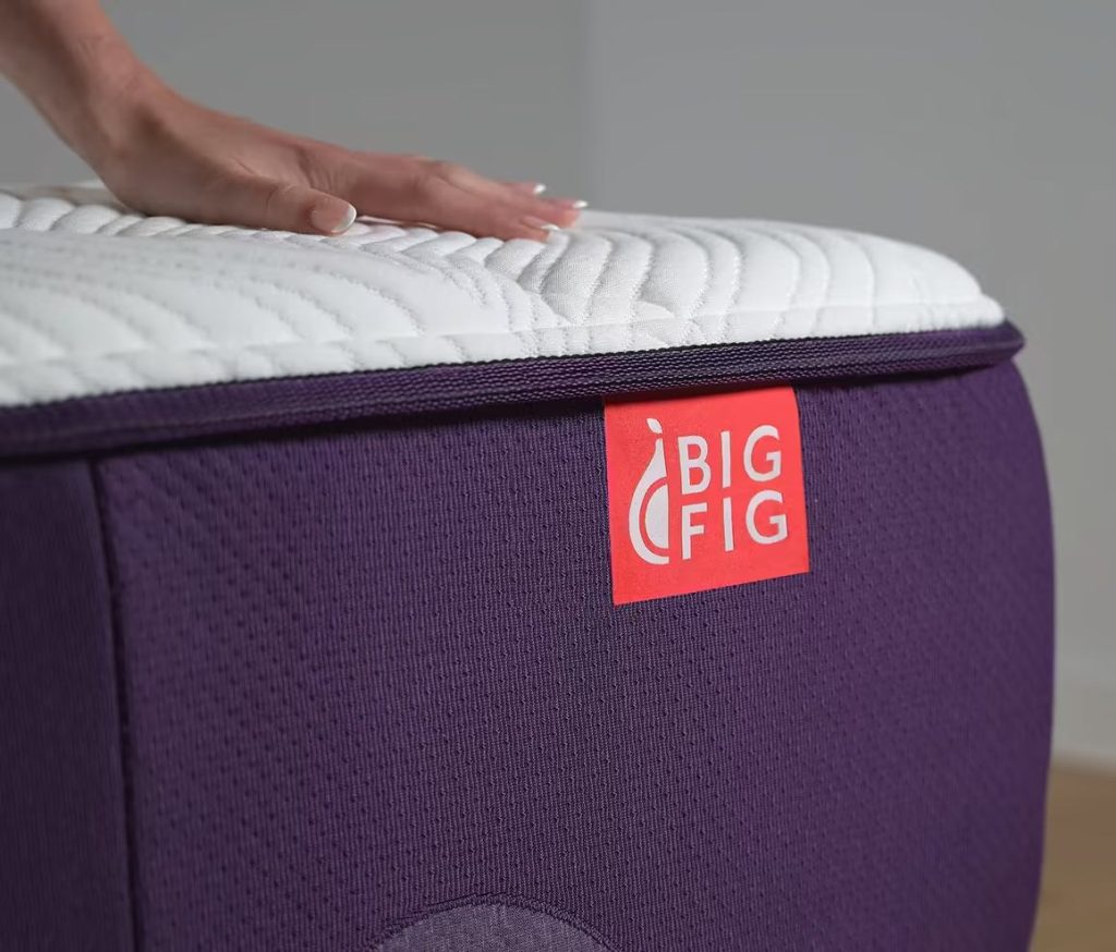Hand pressing the quilted top of the Big Fig Classic Mattress