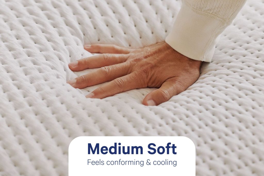 Hand pressing the textured QuickCool cover of the Casper Snow Max, labeled medium soft