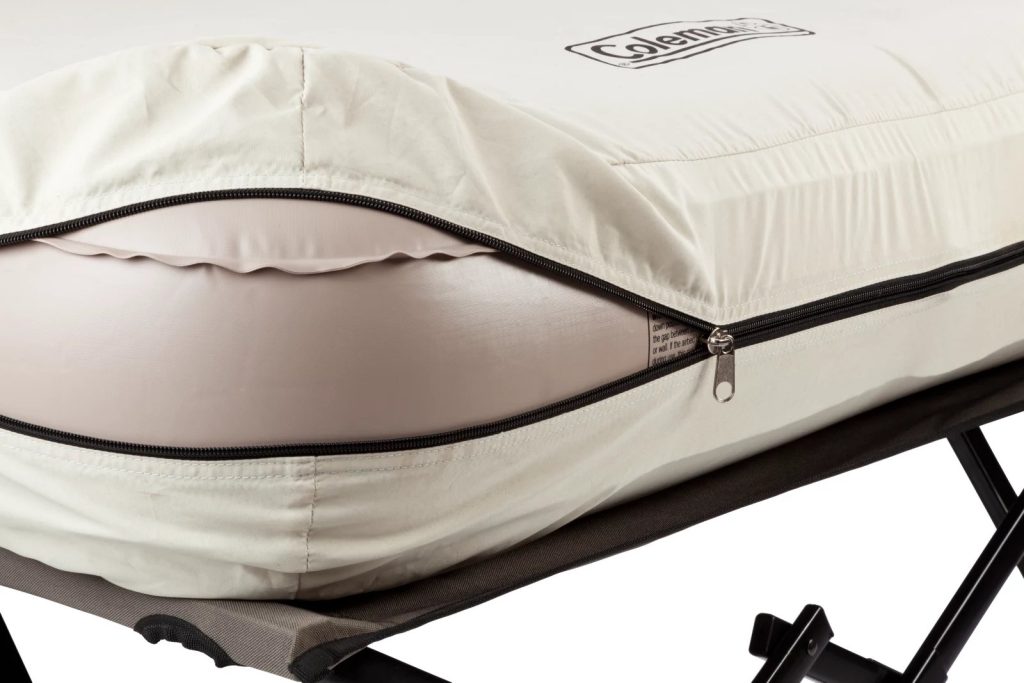 Zippered sewn-in cover holding the air bed on the Coleman Airbed Cot
