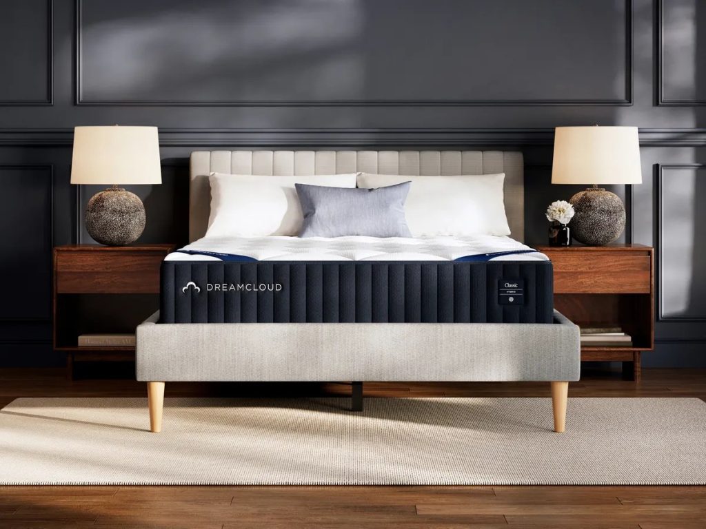 DreamCloud Classic Hybrid mattress, front view on an upholstered bed