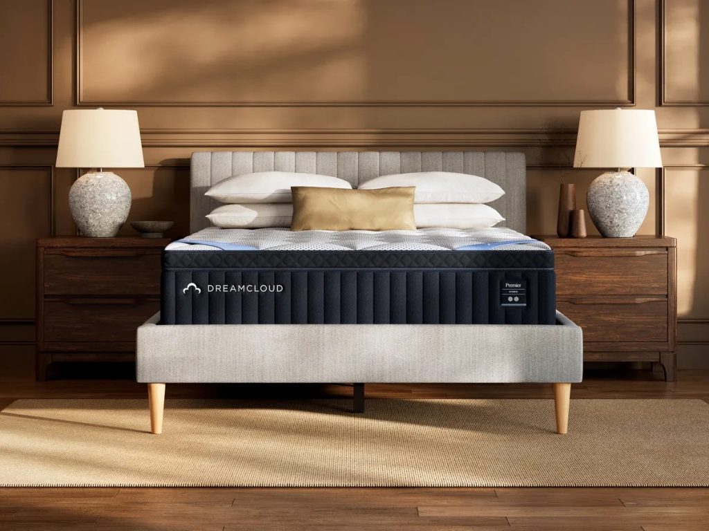 DreamCloud Premier Hybrid mattress, front view on an upholstered bed