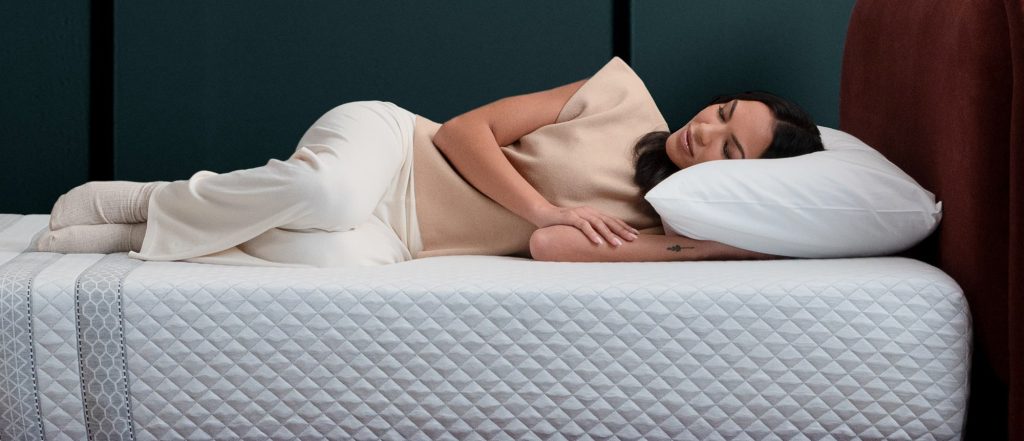 Woman sleeping on her side on the Leesa Sapira Hybrid Mattress