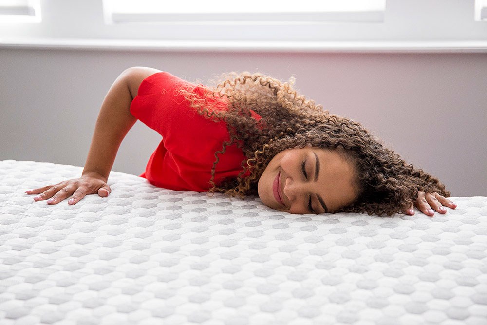 Woman pressing into the soft side of the Layla Memory Foam Mattress