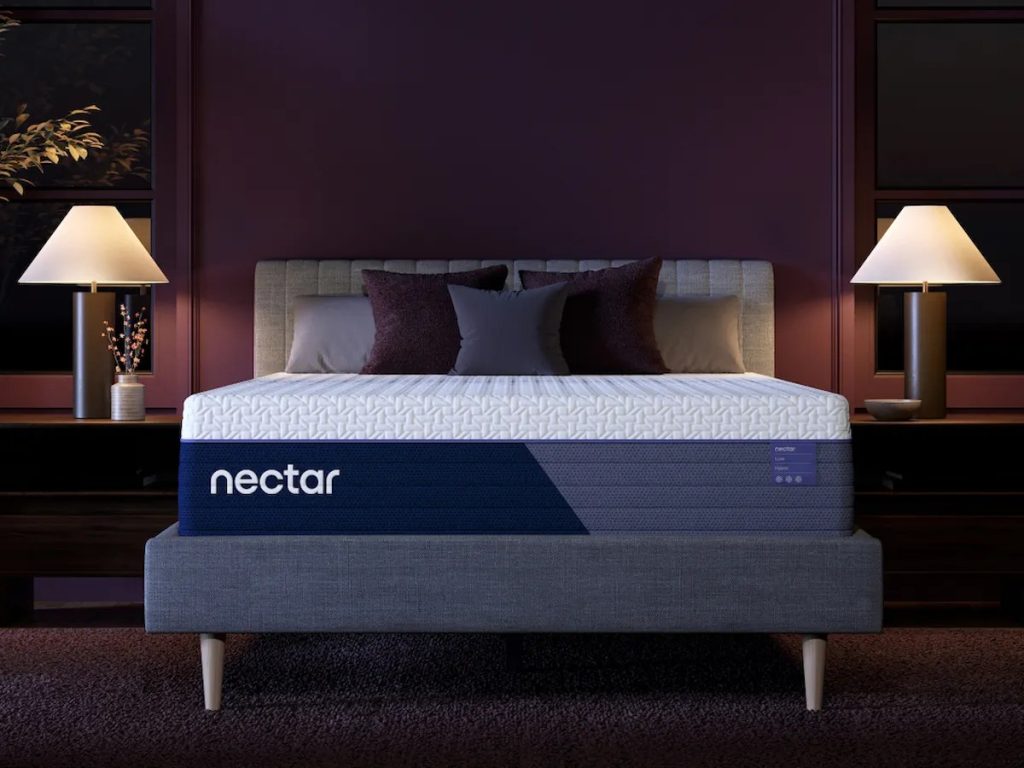 Nectar Luxe Hybrid mattress, front view on an upholstered bed