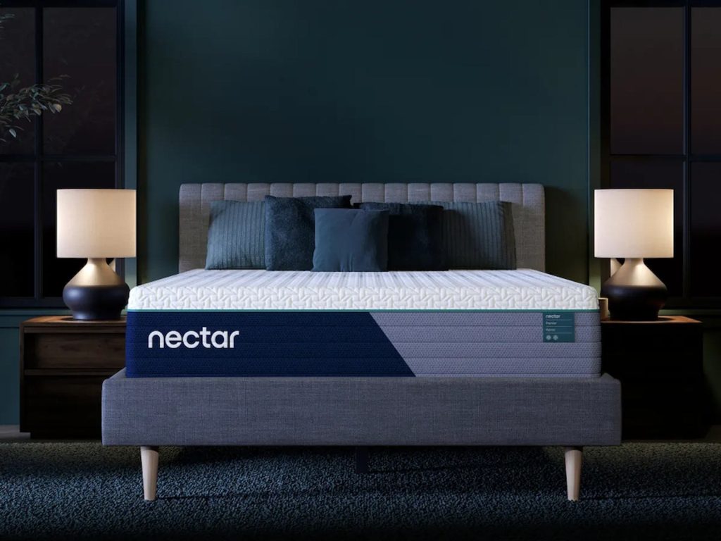 Nectar Premier Hybrid mattress, front view on an upholstered bed
