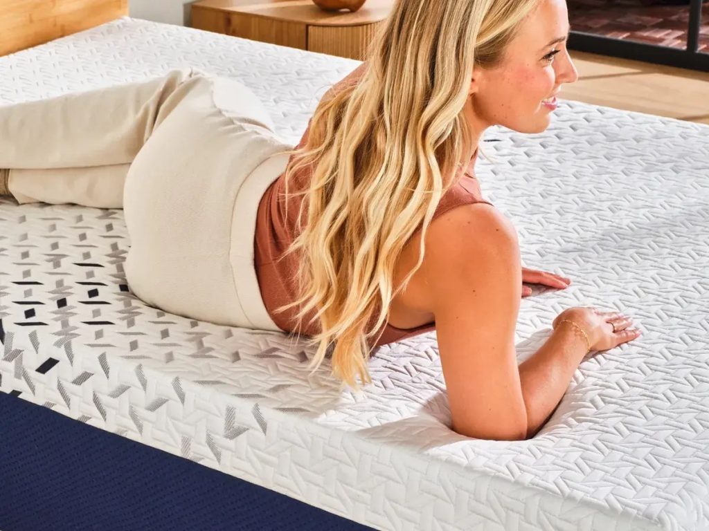 Woman lying on her stomach on the Nectar Ultra Hybrid mattress