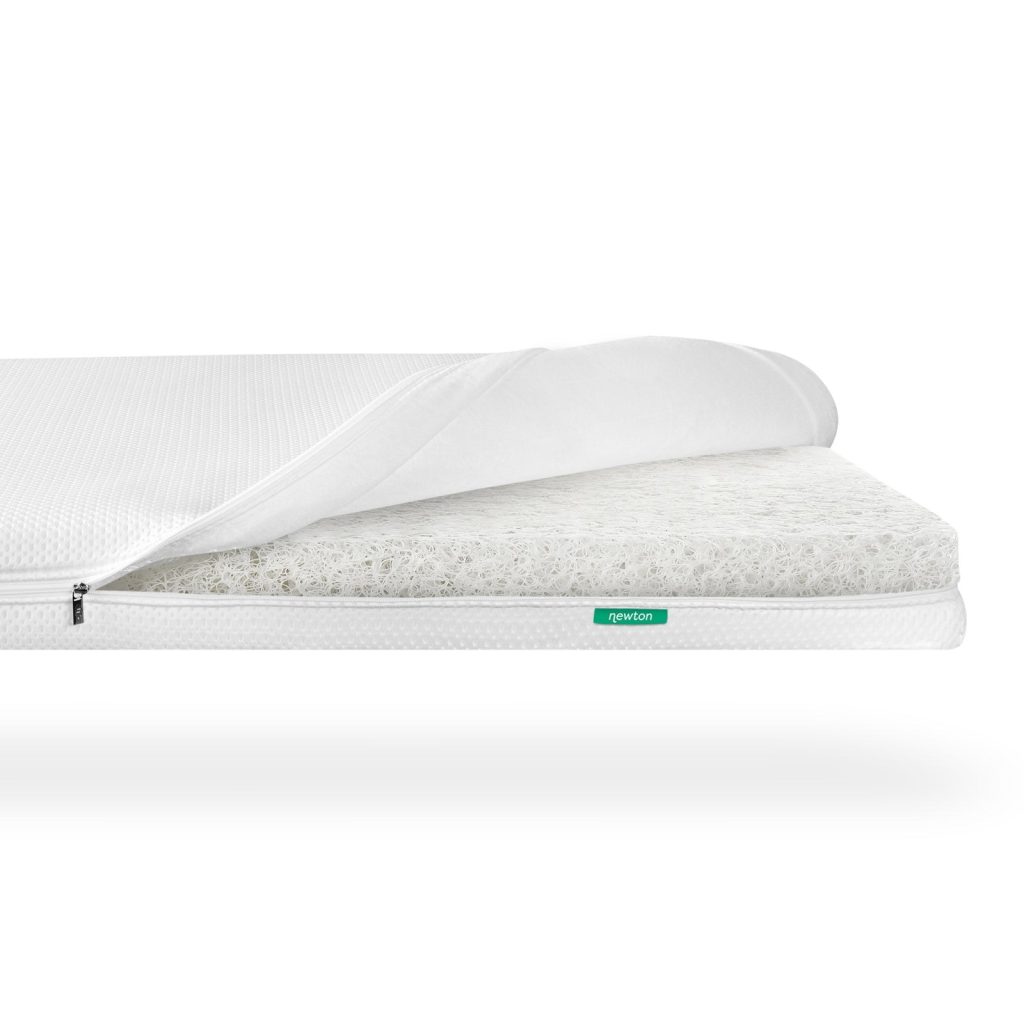 Newton Baby Essential crib mattress with the eyelet cover unzipped over the Wovenaire core
