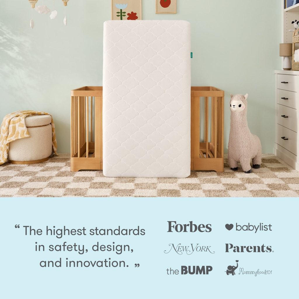 Newton Original crib mattress standing upright between two cribs