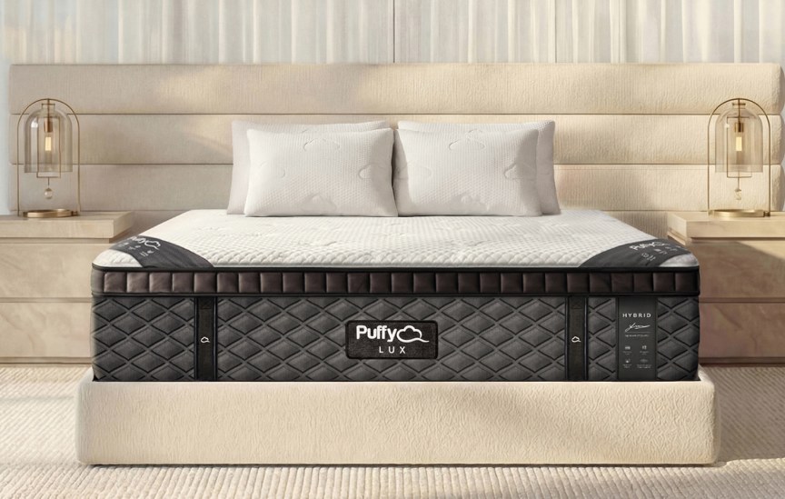 Puffy Lux Hybrid Mattress with pillows on a bed with lamps