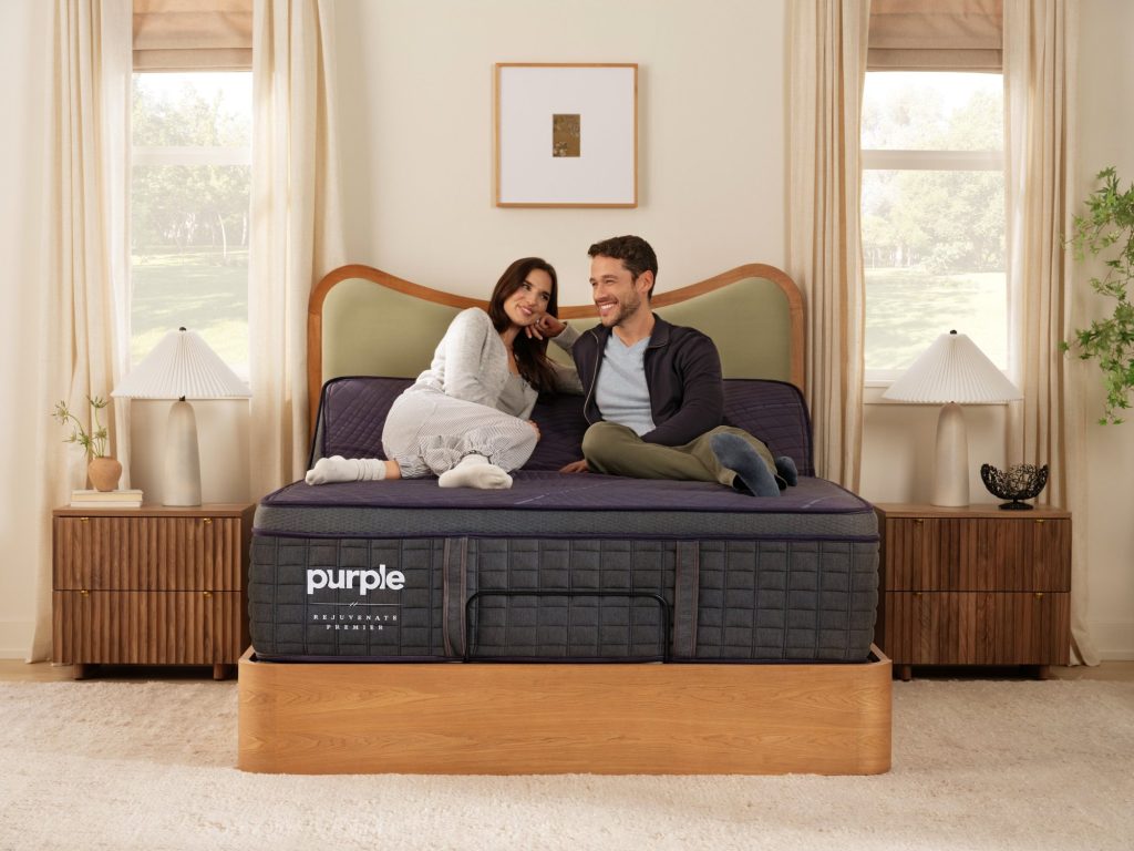 Couple sitting on the Purple RejuvenatePremier in a bedroom