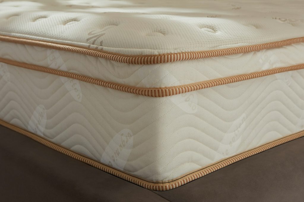 Corner of the Saatva Classic showing the Euro pillow top and quilted border