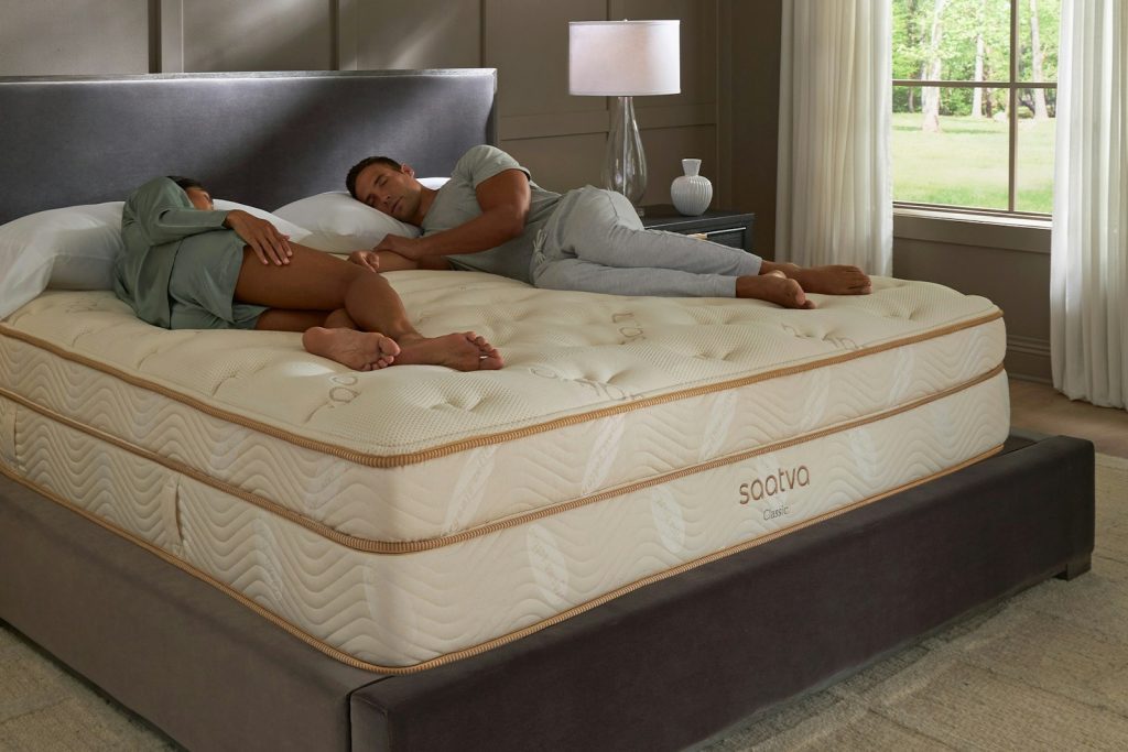 Couple relaxing on the Saatva Classic mattress