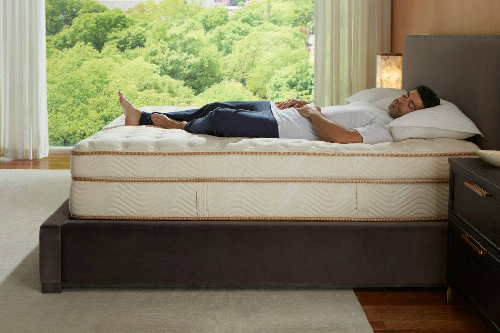 Man lying on his back on the Saatva Classic mattress