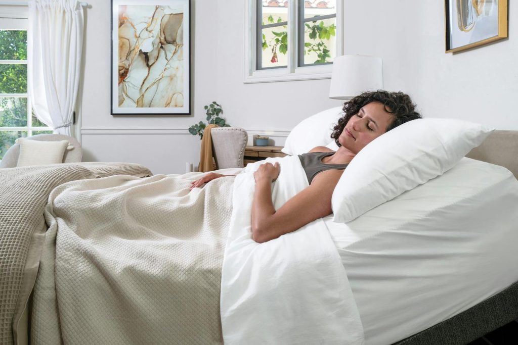 Woman asleep on her side on the Saatva Contour5