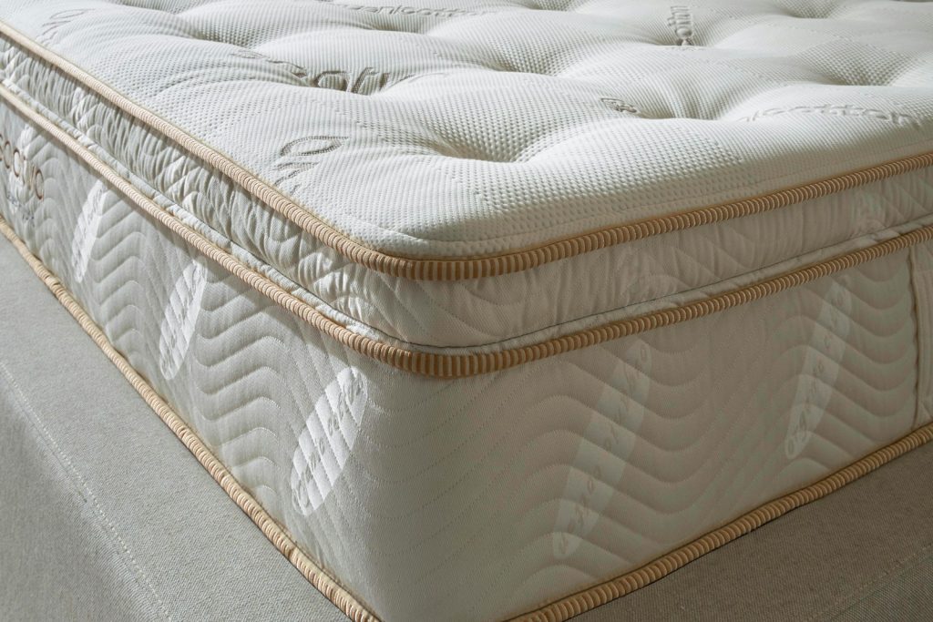 Corner of the Saatva Latex Hybrid showing the tufted cover and border
