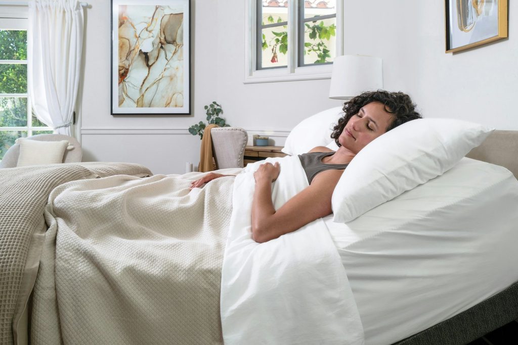 Person resting on the Saatva Memory Foam Hybrid mattress