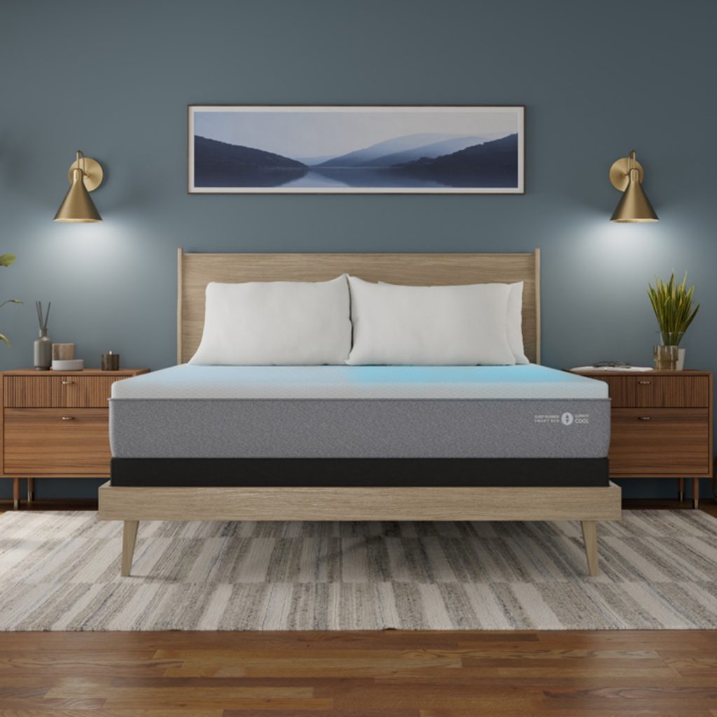Sleep Number ClimateCool on a light wood bed between two wall lamps