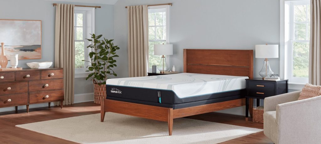 TEMPUR-Adapt mattress on a wooden bed frame in a bright bedroom