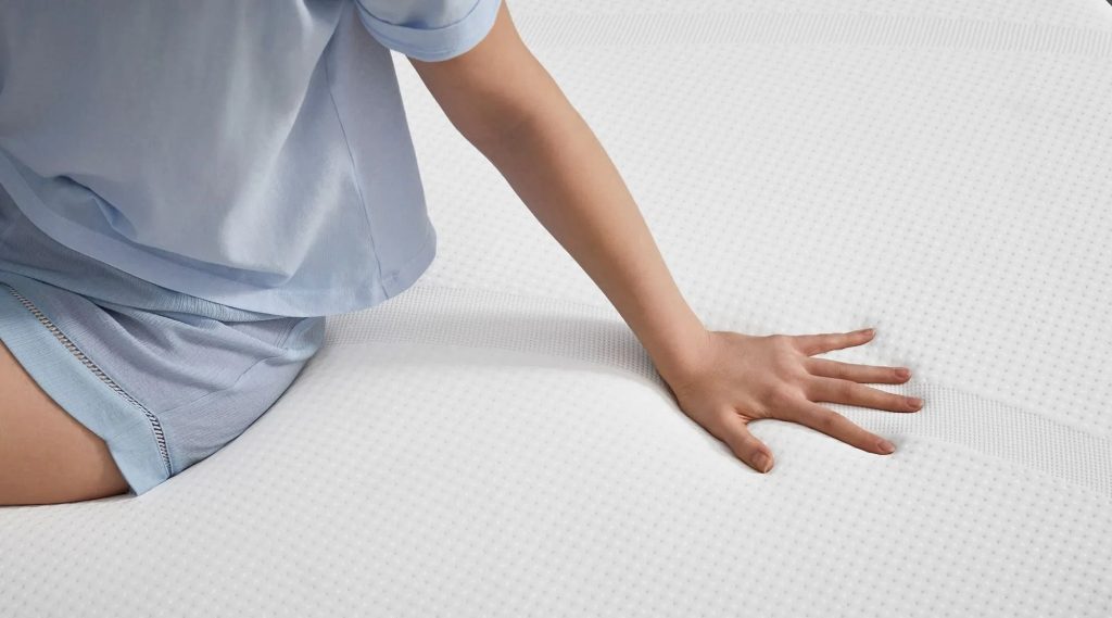 Hand pressing into the TEMPUR-Cloud cover to show the foam response