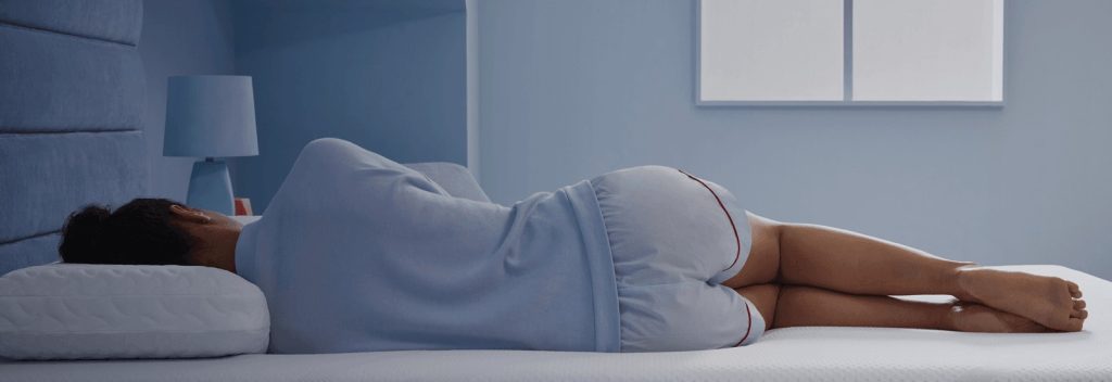 Woman sleeping on her side on a TEMPUR-Cloud mattress