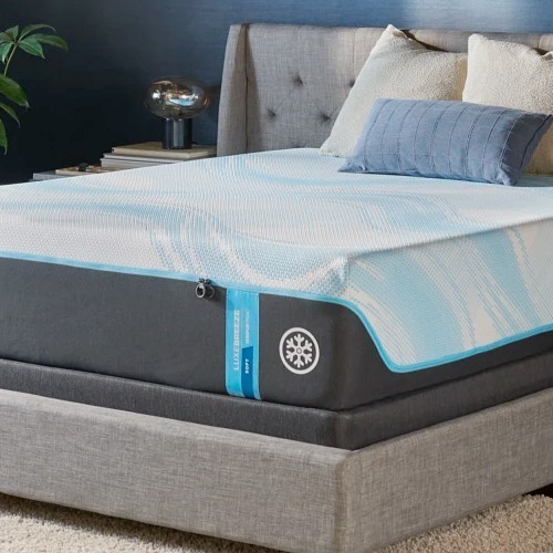 Corner of the TEMPUR-LuxeBreeze on a gray upholstered bed