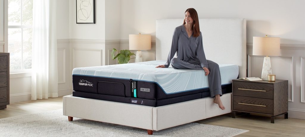 Woman sitting on the edge of a TEMPUR-ProAdapt mattress